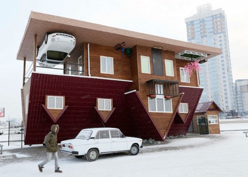 A man passes a house built upside-down in Russia's Siberian city of Krasnoyarsk